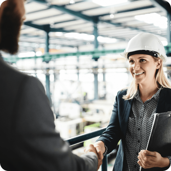 Manufacturing process management software shows two people shaking hands.