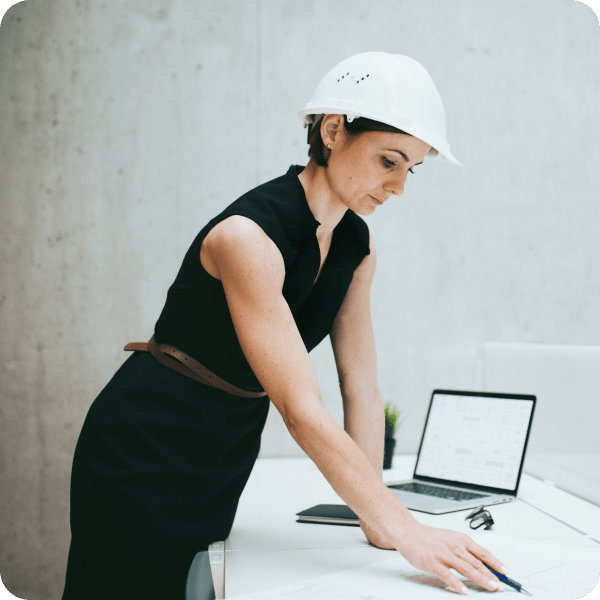Construction document management software being used by a person wearing a hard hat.