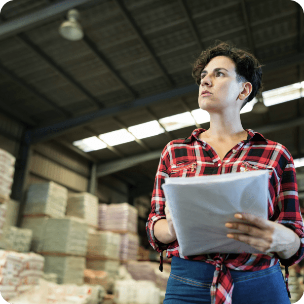 Transportation and logistics automation image of a person stock taking in a warehouse.